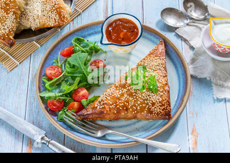 Samossas de poulet géant avec chutney de mangue et une salade fraîche, saupoudré de graines de sésame Banque D'Images