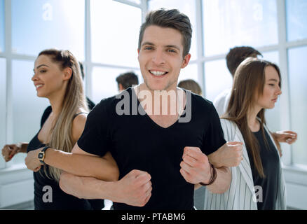 Young business team standing in a circle Banque D'Images