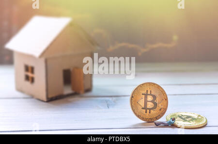 Bitcoin, concept réussi de trader figurine miniature assis sur maison en carton avec bitcoin Banque D'Images