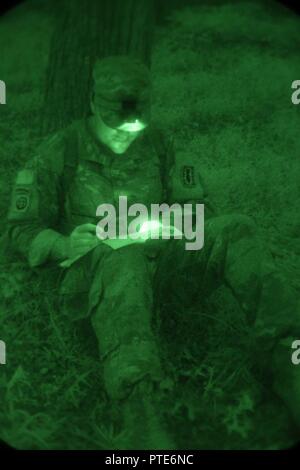 La CPS de l'armée américaine. Luke Carter, 52e Groupe de munitions (NEM), parcelles ses points au cours d'une nuit d'évaluation de la navigation terrestre, Aberdeen Proving Ground, Md., le 12 juillet 2017. Le 20e Concours de meilleur guerrier CBRNE est un concours au niveau de la division qui permettra d'identifier un soldat et un sous-officier à passer à la concurrence FORSCOM Meilleur guerrier. Banque D'Images