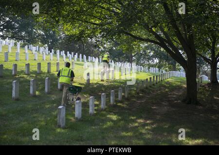 Jeter les bénévoles de la chaux dans l'article 31 de cimetière National d'Arlington, Arlington, Va., le 17 juillet 2017. Plus de 400 professionnels ont participé à paysage bénévole l'Association nationale des professionnels du paysage et de renouvellement annuel 21 souvenir à l'ANC. Banque D'Images