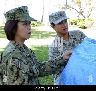 Les participants de l'urgence sanitaire dans de grandes populations (H.E.L.P.) prendre part à un exercice de création de l'abri à l'hôtel Hale Koa à Honolulu, le 14 juillet. Le H.E.L.P. est un cours de deux semaines, cours de formation de niveau universitaire offrant aux participants une compréhension des principaux problèmes de santé publique auxquels sont confrontées les populations touchées par les catastrophes naturelles et les situations d'urgence complexes. Banque D'Images