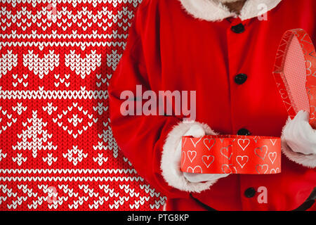 Image composite du père noël de l'ouverture d'une boîte-cadeau Banque D'Images