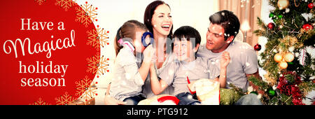 Image composite de happy family Playing with christmas gifts Banque D'Images