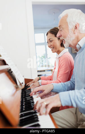 Senior couple playing piano Banque D'Images