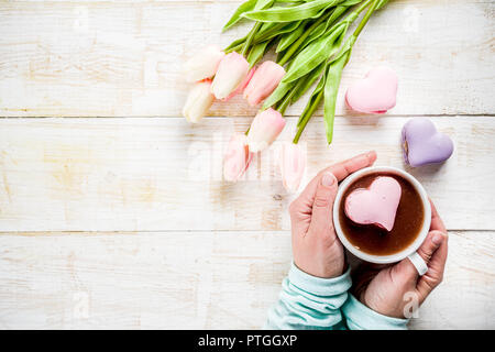 Fille de boire du chocolat chaud avec des guimauves en forme de coeur, Valentine's Day celebration, mains dans la photo, vue d'en haut, copy space Banque D'Images