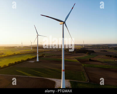 Groupe d'éoliennes autour de drone aérien vue dans le coucher du soleil. Banque D'Images