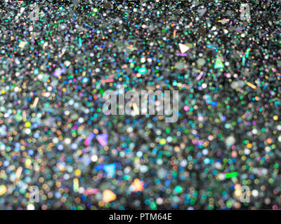 Beau bokeh dot. Paillettes holographique brouillée sur fond noir. L'art abstrait multicolor glitter bokeh background. Banque D'Images