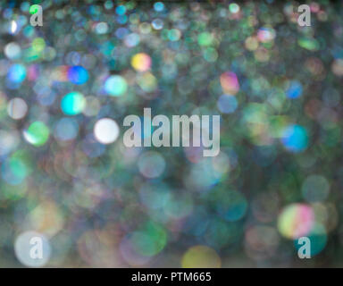 Beau bokeh bulle. Paillettes holographique brouillée sur fond noir. L'art abstrait multicolor glitter bokeh background. Banque D'Images
