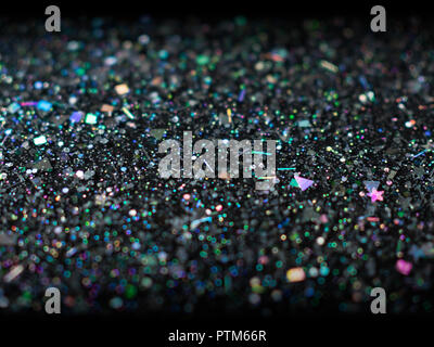 Paillettes holographiques sur fond noir. L'art abstrait multicolor glitter. Banque D'Images