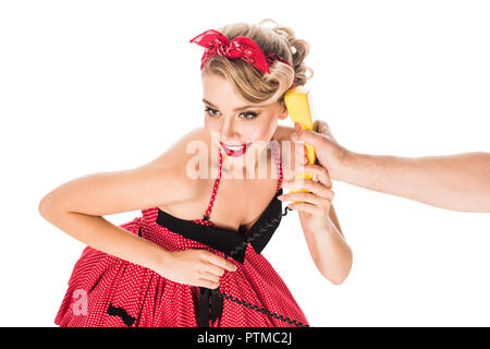 Belle femme en robe retro vintage parle sur téléphone en main mâle isolated on white Banque D'Images