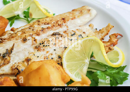 Poêlée de filet de poisson blanc garnie de pommes de terre, les tranches de citron et le persil, cuisine Libanaise Banque D'Images