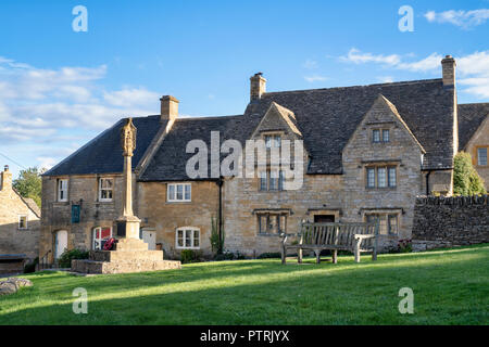 Mémorial de guerre et chalets. Guiting Power, Cotswolds, Gloucestershire, Angleterre Banque D'Images