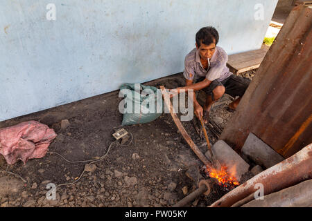 LUANG PRABANG, LAOS - 8 octobre : un homme non identifié s'agite et le chauffe en métal à une forge à Luang Prabang, Laos le 8 octobre 2017. Banque D'Images