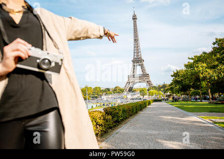 Woman pointing sur la célèbre Tour Eiffel en voyage à Paris. Image recadrée avec pas de visage Banque D'Images