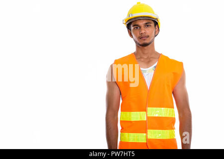 Studio shot of young handsome Indian man construction worker Banque D'Images