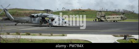 La DOMINIQUE (sept. 27, 2017) Marine et l'Armée de terre et le personnel de stand sur le tarmac de l'aéroport comme Douglas-Charles ils se préparent à évacuer les résidents de la Dominique. Les personnes évacuées sont transportées vers les aéroports de l'île pour le transfert vers les îles de la Martinique et de la Guadeloupe. Le ministère de la Défense soutient United States Agency for International Development (USAID), le principal organisme fédéral, en aidant les personnes touchées par l'Ouragan Maria afin de minimiser la souffrance et est une composante de l'ensemble de l'intervention. Banque D'Images