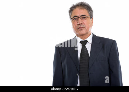 Studio shot of Persian senior businessman wearing eyeglasses Banque D'Images