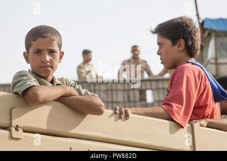 Les enfants arrivent à un point de contrôle de personnes déplacées dans la région de Dibis, l'Iraq, le 30 septembre 2017. Banque D'Images