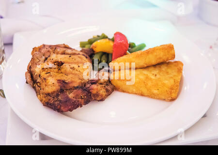 Restaurant plat principal servi sur une plaque blanche. Délicieux rôti avec des légumes et de la purée de pommes de terre en croûte sur une plaque. Restauration à un banquet. Restaur Banque D'Images