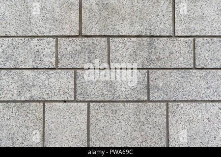 Mur de brique en granit gris texture de fond avec différentes tailles de blocs rectangulaires dans un contexte Banque D'Images