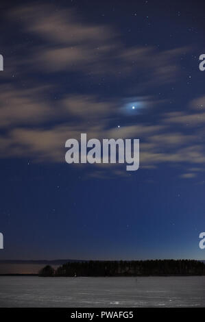 Concert de planètes Jupiter et Vénus le ciel nocturne au-dessus de paysage d'hiver enneigé. Banque D'Images