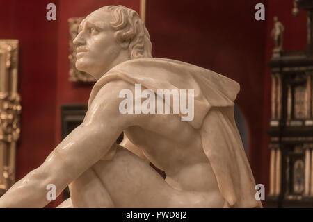 L'Arrotino, alias le couteau broyeur ou le Sythian, sculpture de marbre sur l'affichage dans la Tribuna prix dans la galerie des Offices à Florence, Italie. Banque D'Images