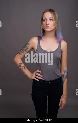 Jeune belle et rebelle avec les cheveux multicolores contre Banque D'Images