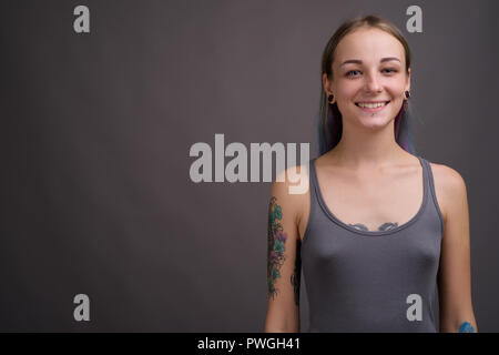 Jeune belle et rebelle avec les cheveux multicolores contre Banque D'Images