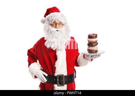 Santa Claus holding a plate of donuts isolé sur fond blanc Banque D'Images