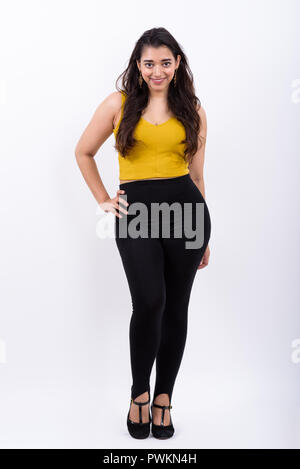 Full body shot of young happy Indian woman smiling with hand on Banque D'Images