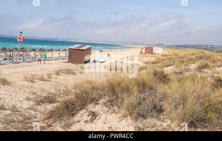 Promenade menant à la plage avec quelques chaises longues. Banque D'Images