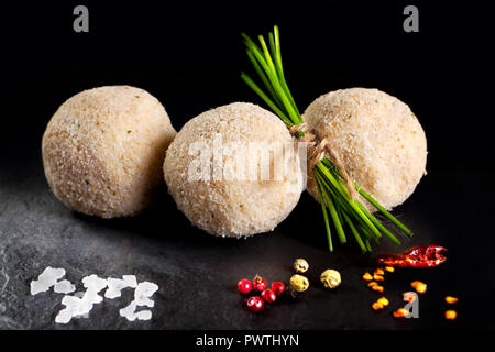 L'alimentation. Les billes de pommes de terre farcies de viande prêt pour la friture. Des tapas espagnoles sur fond noir de l'ardoise noire Banque D'Images