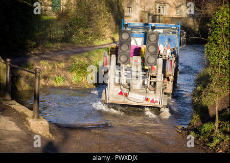 L'entretien d'une route, un camion traverse le village de Lacock dans le Wiltshire England UK Banque D'Images