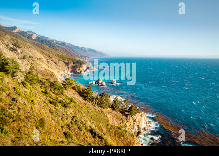 Vue panoramique sur la côte sauvage de Big Sur avec montagnes Santa Lucia le long de la route 1 célèbre illuminée en belle lumière du soir à soleils d'or Banque D'Images