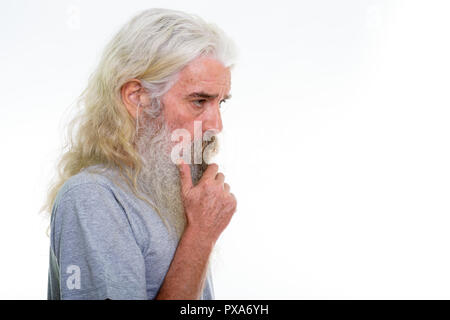 Vue de profil d'homme barbu senior thinking with hand on chin Banque D'Images