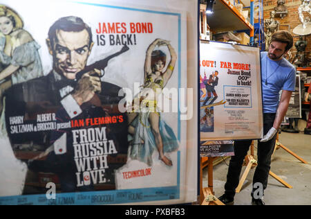 À l'embargo Lundi 22 octobre 0001 Soutenir l'employé du magasin Matt Story ajuste une affiche pour le 1969 film de James Bond Au Service Secret de Sa Majesté lors d'un aperçu de la prochaine vente aux enchères d'affiches de cinéma à la prop Store siège social près de Rickmansworth. Banque D'Images