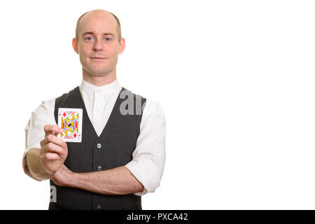 Bald Caucasian man holding magicien carte Valet de carreau Banque D'Images