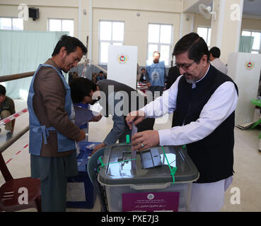 Kaboul, Afghanistan. 21 Oct, 2018. Un électeur dépose son bulletin de vote à un bureau de vote pendant les élections parlementaires à Kaboul, capitale de l'Afghanistan, le 21 octobre 2018. Le processus de vote des élections parlementaires afghanes conclu dimanche soir et la poursuite de dépouillement du scrutin, le président de la Commission électorale indépendante a déclaré. Credit : Rahmat Alizadah/Xinhua/Alamy Live News Banque D'Images