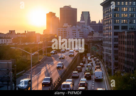 La circulation à l'heure de pointe sur le Brooklyn Queens Expressway à New York avec le coucher du soleil la lumière en arrière-plan Banque D'Images