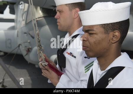 Plage de sable blanc, l'Okinawa (5 juin 2017) Airman Stephon Smith, de Dallas, (avant) et d'un membre de Tyler Forester, de Blair, Okla., attendre l'appel pour décaler les couleurs au cours de l'ancre et la mer détail à bord du navire d'assaut amphibie USS Bonhomme Richard (DG 6) que le navire arrive à la plage blanche de lancer l'installation navale Marines de la 31e Marine Expeditionary Unit (MEU). Au cours de la visite, le navire s'embarqueront 31e MEU personnel, de véhicules et de matériel, avant de poursuivre d'un service de patrouille. Bonhomme Richard, navire amiral du Bonhomme Richard groupe amphibie, est sur une patrouille de routine, dans l'exploitation Banque D'Images