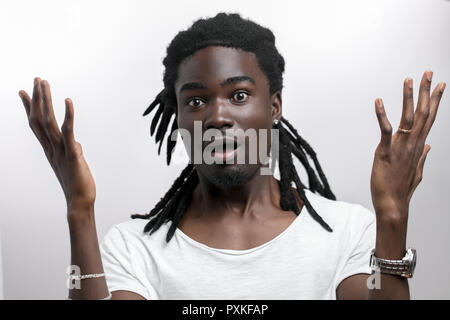 Choqué African American man wearing white T-shirt looking at camera de surprise Banque D'Images