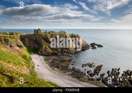 Plage de galets à Old Hall Bay Mer du Nord avec Donnottar château forteresse médiévale clifftop ruines Écosse Royaume-uni Stonehaven Banque D'Images