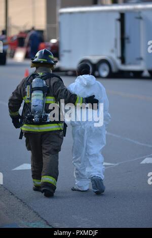 Un membre du Service des incendies du canton d'escorte une victime simulée au cours de l'opération vigilant à Canton, Catamount NC, le 10 juin 2017. L'opération de vigilance (Catamount OEV) est un programme conjoint et civils des opérations nationales et régionales NCNG la sécurité intérieure de l'exercice. Banque D'Images