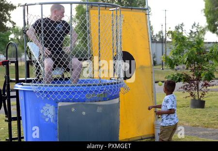 Un champ McChord dunks dépendante capitaine principal Sgt. James Niblock, 627ème escadron de préparation logistique de distribution et de déploiement, surintendant de vol dans une cuve d'immersion au Cœur d'intervalle le dîner 6 juin 2017, à Joint Base Lewis-McChord, dans l'état du dîner informel admis à assister aux aviateurs en civil avec leurs conjoints et enfants, et participer à une variété d'activités. Banque D'Images