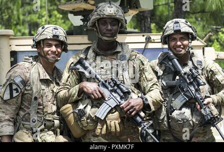 Le Sgt. 1re classe Antonio Clayton, père de 5 (une de plus sur le chemin) et sergent du peloton pour la 2e peloton, Compagnie D, 1er bataillon du 501ème Parachute Infantry Regiment d'infanterie, 4e Brigade Combat Team (Airborne), 25e Division d'infanterie, pose pour une photo avec deux membres de son peloton pendant une rotation au Joint Readiness Training Centre, Fort Polk, en Louisiane le 17 juin. 'Vous devez être en mesure de traiter avec différents knuckleheads et des personnalités différentes, des points de vue et différentes façons de faire les choses," dit Clayton. "La seule différence, c'est, je ne peux pas nécessairement leur donner la fessée. Néanmoins, la plupart des rewar Banque D'Images