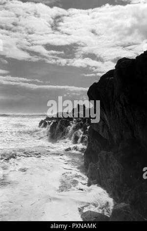 Sea Cliff contre ciel bleu profond avec des nuages blancs. Soft rétroéclairées. Analogique : 35 mm film dia. Converti en noir et blanc. Banque D'Images