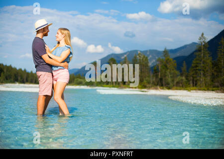 Jeune couple debout dans l'eau, Faire place au Banque D'Images