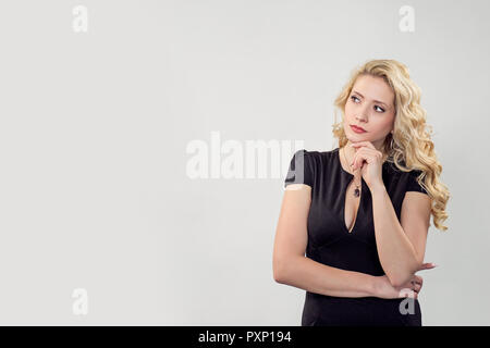 Belle pensive woman in black dress Banque D'Images