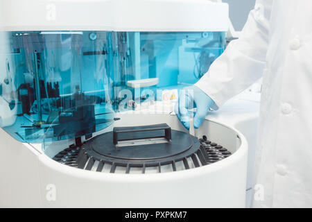 Doctor putting tubes de sang dans la centrifugeuse pour le test Banque D'Images